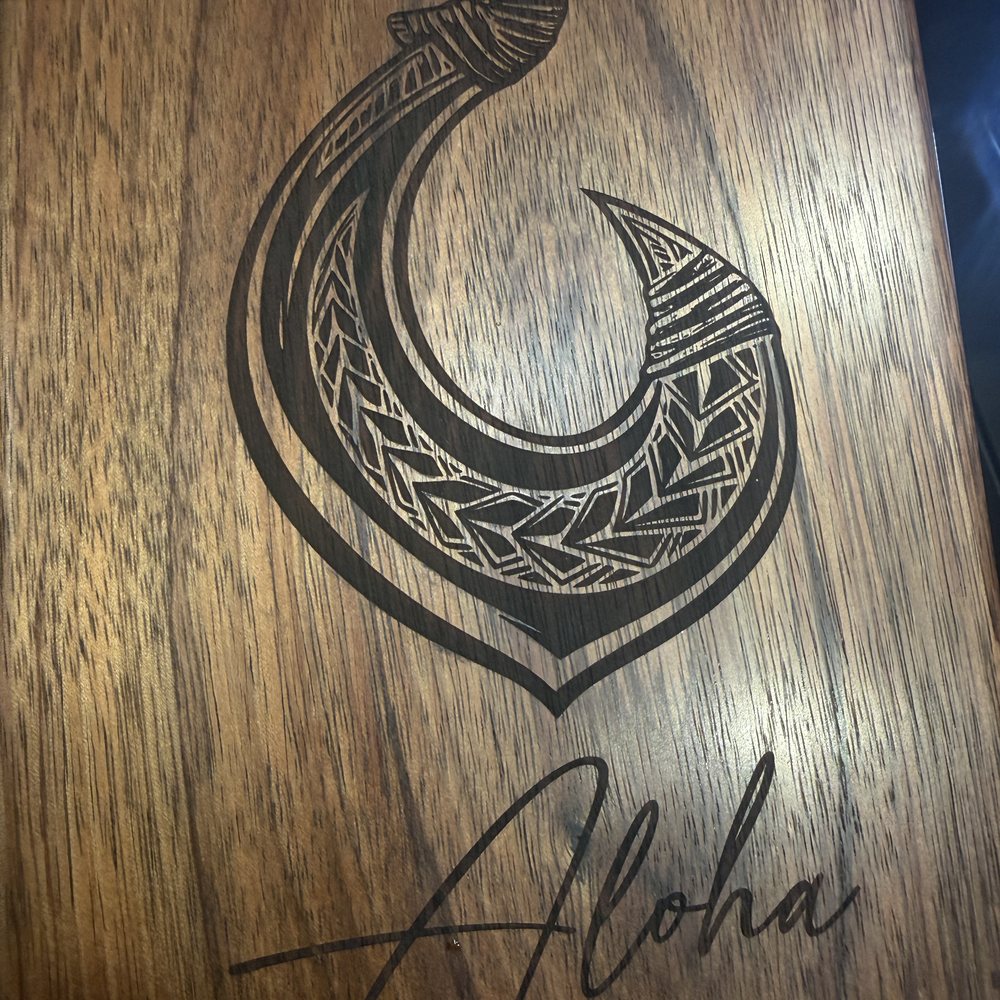 Custom wooden cremation urn laser engraved with a Polynesian makau fish hook and Aloha script